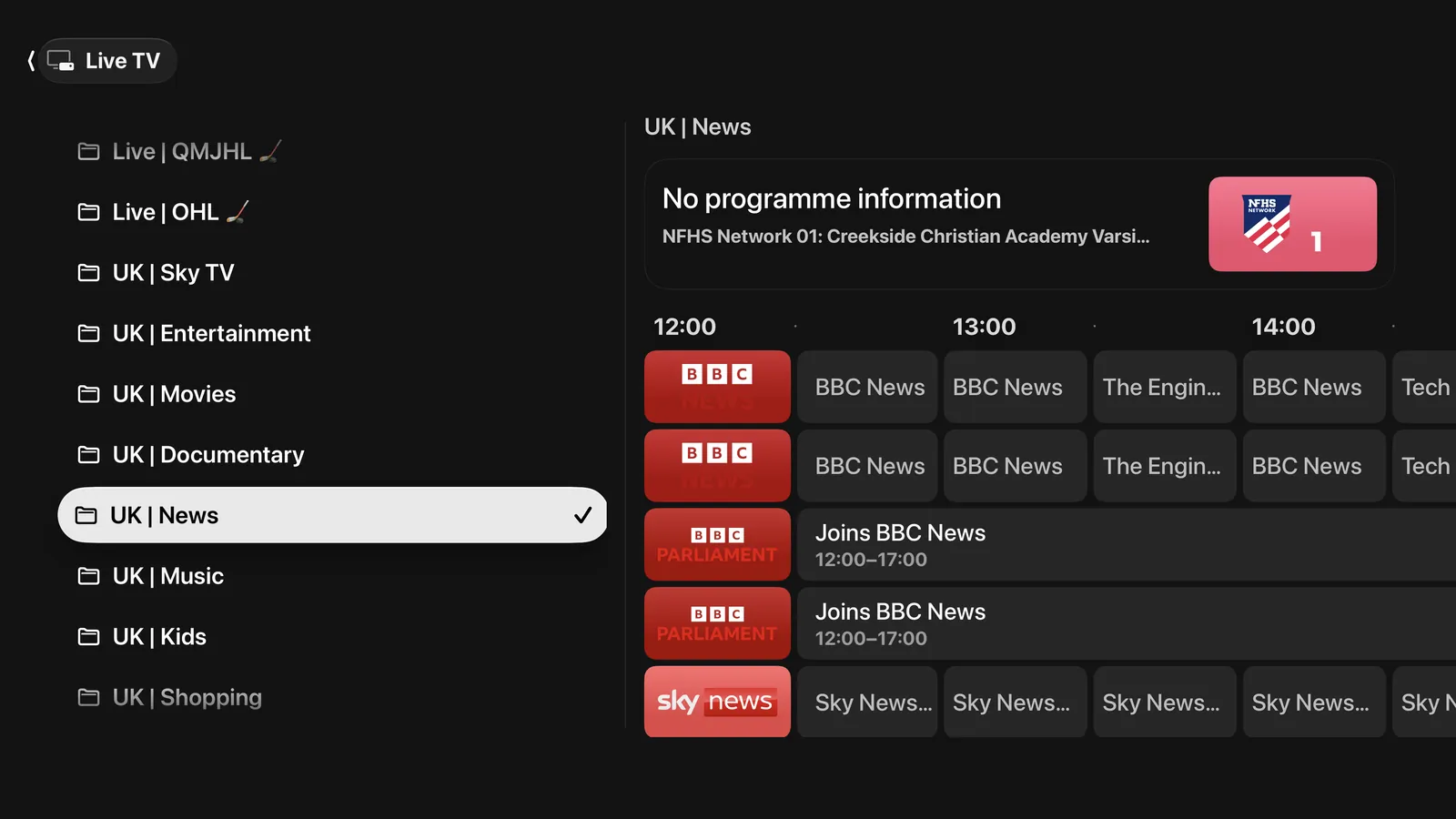 The Live TV guide on Apple TV: categories down the left with UK News picked out, and the afternoon's schedule beside it — channels in rows, programmes across the columns.